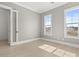 Sunlit bedroom with two windows and neutral walls for a bright, airy feel at 509 Rhythm St, Summerville, SC 29486