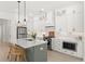 Bright kitchen features custom white cabinetry, pendant lighting, stainless appliances, and a center island with seating at 509 Rhythm St, Summerville, SC 29486