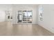 Bright living room area with sliding doors leading to a screened patio and a modern chandelier at 509 Rhythm St, Summerville, SC 29486