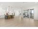 Open concept living room with kitchen, bar stool seating, and sliding doors leading to an enclosed patio at 509 Rhythm St, Summerville, SC 29486