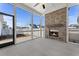 Covered and screened patio with a brick fireplace and a view of the fenced yard at 509 Rhythm St, Summerville, SC 29486