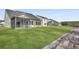 View of the home's backyard showing the lawn, fence, screened in porch, and the home's exterior at 511 Verdi Dr, Summerville, SC 29486