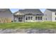 View of the home's backyard showing the lawn, fence, screened in porch, and the home's exterior at 511 Verdi Dr, Summerville, SC 29486