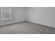 Clean bedroom features a window with blinds, neutral carpet, and fresh paint at 511 Verdi Dr, Summerville, SC 29486