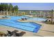 Stunning community pool with splash pad, lounge seating, and well-maintained landscaping near the lake at 511 Verdi Dr, Summerville, SC 29486