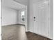 Bright foyer showcasing hardwood flooring, a white front door, and an open doorway leading to the living area at 511 Verdi Dr, Summerville, SC 29486