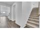 Inviting hallway featuring hardwood flooring, a staircase with carpeted steps, and an open view to the living spaces at 511 Verdi Dr, Summerville, SC 29486