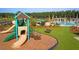 A playground with slides, a climbing structure, and a seating area next to the community pool at 511 Verdi Dr, Summerville, SC 29486