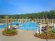 Community pool with palm trees, lounge chairs, umbrellas, pergolas, and a zero-entry splash pad at 511 Verdi Dr, Summerville, SC 29486