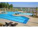Stunning community pool area with sun loungers, umbrellas, tables, and lake views at 511 Verdi Dr, Summerville, SC 29486