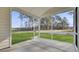 A screened porch with a concrete floor, a ceiling, and a view of the backyard and woods at 511 Verdi Dr, Summerville, SC 29486