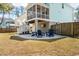 View of backyard with patio, fire pit, and screened-in porch at 520 Sanders Farm Ln, Wando, SC 29492