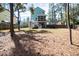 Large backyard with mature trees, patio, and a screened porch at 520 Sanders Farm Ln, Wando, SC 29492