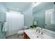 Well-lit bathroom with a sink, toilet, and shower with a white shower curtain at 520 Sanders Farm Ln, Wando, SC 29492