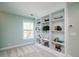 Bright bedroom featuring built-in bookshelves and ample natural light through a large window at 520 Sanders Farm Ln, Wando, SC 29492