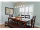 Cozy dining room featuring a dark wood table, bench, chairs, and a light fixture with glass shades above at 520 Sanders Farm Ln, Wando, SC 29492