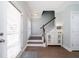 Welcoming entryway features hardwood floors, a staircase, and elegant decor, offering a stylish introduction to the home at 520 Sanders Farm Ln, Wando, SC 29492