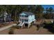 Charming two-story coastal home featuring double porches, a landscaped yard, and a stilt foundation at 520 Sanders Farm Ln, Wando, SC 29492