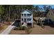 Charming two-story coastal home featuring double porches and a well-manicured lawn at 520 Sanders Farm Ln, Wando, SC 29492