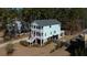 Beautiful coastal-style home with double porches and lush landscaping at 520 Sanders Farm Ln, Wando, SC 29492