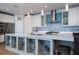 Modern kitchen with white cabinetry, a large island, and a blue tile backsplash at 520 Sanders Farm Ln, Wando, SC 29492