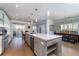 Bright and open kitchen featuring a large island, stainless steel appliances, and hardwood flooring at 520 Sanders Farm Ln, Wando, SC 29492