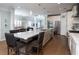 Well-lit kitchen with a central island, stainless steel appliances, and a dining area in the background at 520 Sanders Farm Ln, Wando, SC 29492