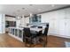 Spacious kitchen featuring a large island with seating, sleek countertops, and modern appliances at 520 Sanders Farm Ln, Wando, SC 29492
