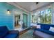 Inviting sunroom with plush seating, string lights, and an open view to the gourmet kitchen at 520 Sanders Farm Ln, Wando, SC 29492