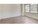 Light-filled room with hardwood floors, base trim, and two windows overlooking the neighborhood at 525 Verdi Dr, Summerville, SC 29486