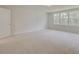 Well-lit bedroom features neutral carpet, white walls, and three bright, sun-filled windows at 525 Verdi Dr, Summerville, SC 29486