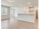 Open-concept living area with modern flooring, granite countertop bar and neutral color palette at 525 Verdi Dr, Summerville, SC 29486