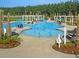 A community pool featuring a splash pad area, lounge chairs, and picnic tables at 525 Verdi Dr, Summerville, SC 29486