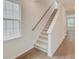 Carpeted stairs with wooden handrail, next to a window, ascending to the upper level at 525 Verdi Dr, Summerville, SC 29486