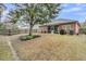 Spacious backyard with a screened in porch, mature tree, and partial fencing at 5408 Overland Trl, North Charleston, SC 29420