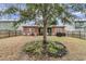 View of backyard with a screened porch, lawn, and mature tree at 5408 Overland Trl, North Charleston, SC 29420