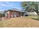 View of backyard with a screened porch, lawn, and mature tree at 5408 Overland Trl, North Charleston, SC 29420