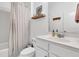Bright bathroom featuring a stylish vanity, modern fixtures, and a shower with a patterned curtain at 5408 Overland Trl, North Charleston, SC 29420