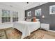 Bright bedroom featuring tray ceilings and large windows that provide ample natural light at 5408 Overland Trl, North Charleston, SC 29420