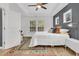 Bright bedroom featuring a ceiling fan and large windows with a dedicated desk area at 5408 Overland Trl, North Charleston, SC 29420