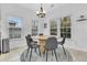 Bright dining area with a round table, stylish chairs, and plenty of natural light from the windows at 5408 Overland Trl, North Charleston, SC 29420