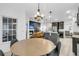 Open dining area with modern table and chairs, seamlessly connected to the kitchen and living room at 5408 Overland Trl, North Charleston, SC 29420