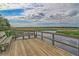 A relaxing dock with a bench offers peaceful water views under a beautiful cloudy sky at 5408 Overland Trl, North Charleston, SC 29420