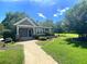Charming home with a well-manicured lawn and inviting brick pathway leading to the entrance at 5408 Overland Trl, North Charleston, SC 29420