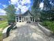 Home exterior featuring a patio with a grill, an outdoor seating area, and lush landscaping at 5408 Overland Trl, North Charleston, SC 29420