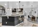 Open kitchen featuring a center island, modern appliances, and stylish pendant lighting at 5408 Overland Trl, North Charleston, SC 29420