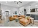 Open-concept living room featuring a large leather sofa, neutral color palette, and ample natural light at 5408 Overland Trl, North Charleston, SC 29420