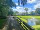 Scenic view of a pond with a fountain, playground, and bridge creating a relaxing community space at 5408 Overland Trl, North Charleston, SC 29420