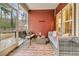 Cozy screened-in porch with comfortable seating and a view of the wooded backyard at 5408 Overland Trl, North Charleston, SC 29420