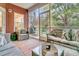 Relaxing screened porch with wicker furniture, inviting cushions, and lush greenery at 5408 Overland Trl, North Charleston, SC 29420